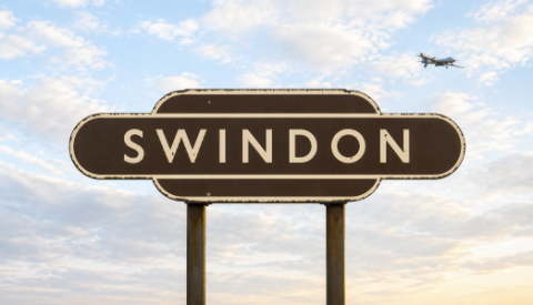 old Swindon railway sign with a military drone in the background