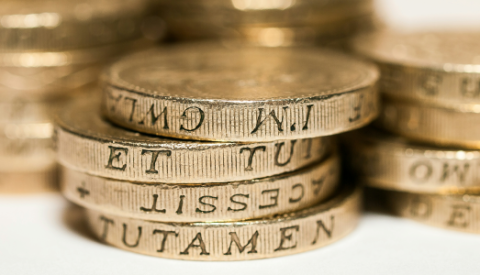 small piles of pound coins