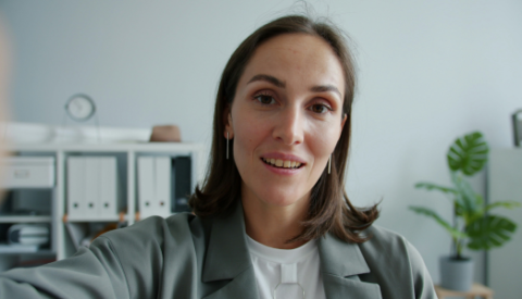 businesswoman looking into a camera during a video call